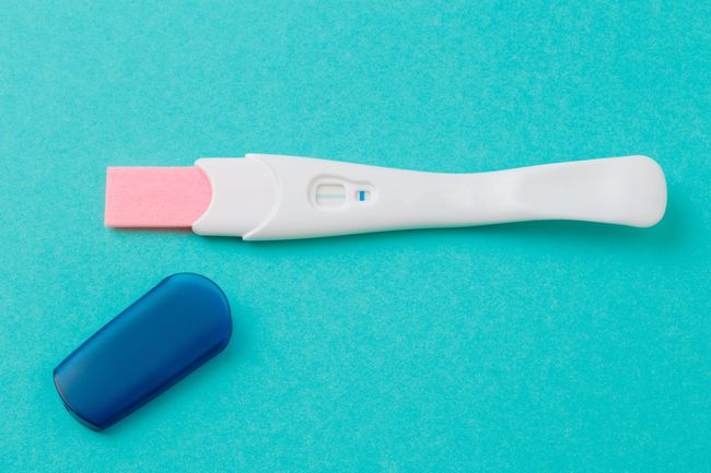 An image of a negative pregnancy test on a blue background.