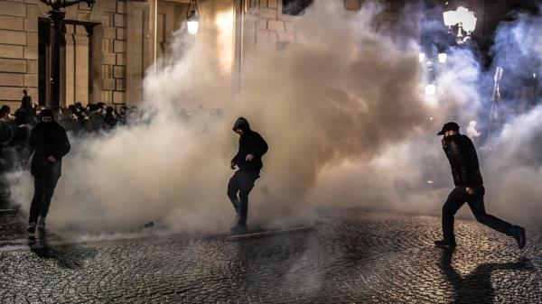 Riot police intervene with tear gas to protesters during the demo<em></em>nstration against the French Government's pension reform in Paris