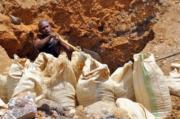 A miner digging for copper in DRC.