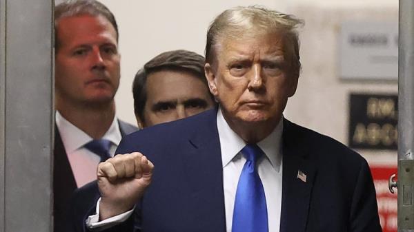 Former US President Do<em></em>nald Trump gestures while he returns to the courtroom for his trial