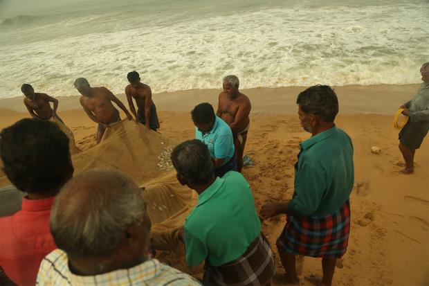 Artisanal fishermen at the Thengapattanam coast complain of negligible catch as they pull the fishing nets. 